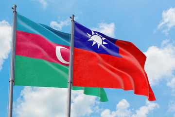 Taiwan and Azerbaijan flags waving in the wind against white cloudy blue sky together. Diplomacy concept, international relations.