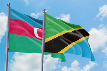 Tanzania and Azerbaijan flags waving in the wind against white cloudy blue sky together. Diplomacy concept, international relations.