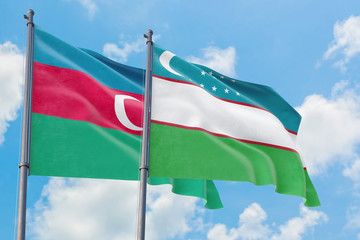 Uzbekistan and Azerbaijan flags waving in the wind against white cloudy blue sky together. Diplomacy concept, international relations.