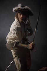 Portrait of pirate filibuster sea robber in suit with guns. Concept photo