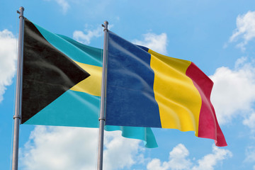 Chad and Bahamas flags waving in the wind against white cloudy blue sky together. Diplomacy concept, international relations.