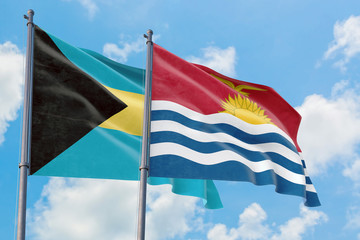 Kiribati and Bahamas flags waving in the wind against white cloudy blue sky together. Diplomacy concept, international relations.