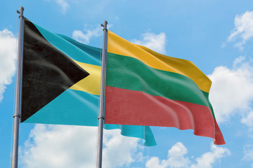 Lithuania and Bahamas flags waving in the wind against white cloudy blue sky together. Diplomacy concept, international relations.