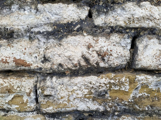 Old Wall with Moldy Peeling White Painting from Humidity. Cracked White Wall as Rusty Concrete Weathered Wall Grunge Background 