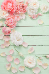pink and white roses on green wooden background