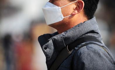 A person wearing a face mask corona covid-19