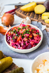 Vinegret or vinaigrette Russian red salad with cooked and pickled vegetables, peas, beetroot. Vegan healthy dietary food