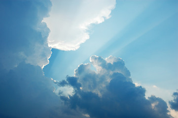 sunbeam radiating from behind the cloud
