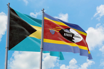 Swaziland and Bahamas flags waving in the wind against white cloudy blue sky together. Diplomacy concept, international relations.