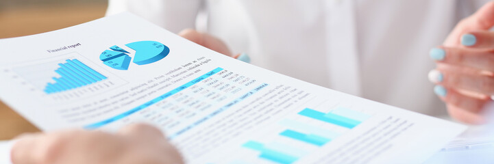 Group of people deliberate on problem with paper infographics hold in hand closeup. White collar check money papers stock exchange market earnings list partnership agreement discussion concept