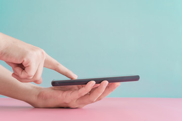 People hand using smartphone with blank pastel clear background. Business, financial, trade stock...