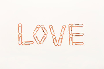 love shaped paperclips on white background
