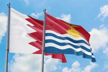Kiribati and Bahrain flags waving in the wind against white cloudy blue sky together. Diplomacy concept, international relations.