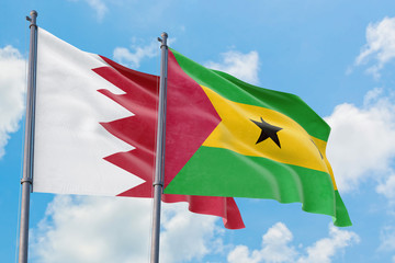 Sao Tome And Principe and Bahrain flags waving in the wind against white cloudy blue sky together. Diplomacy concept, international relations.