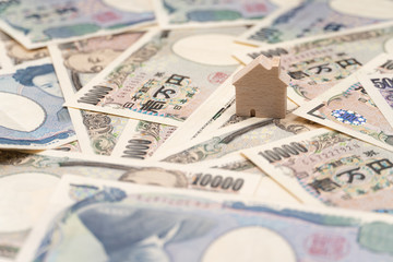 Close up little wooden house on japanese currency yen money banknote. Background concept for japan  real estate industry economy.