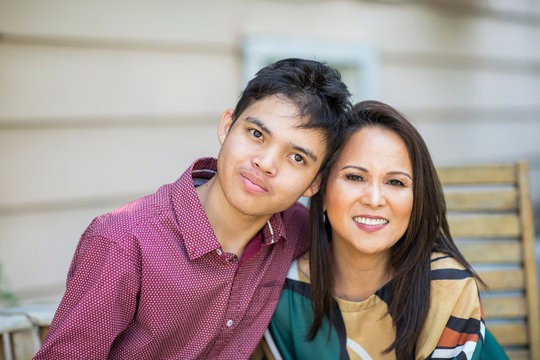 Portrait of an Asian mother with her teenage son.