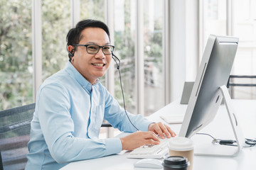 Service phone operators use headset and computer, focus on people answers incoming telephone calls directing to appropriate department, takes messages from clients, assistance distantly concept.