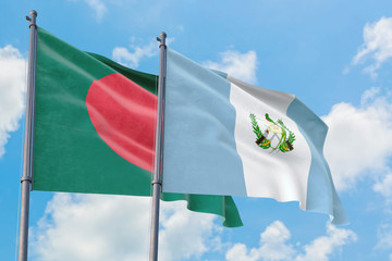 Guatemala and Bangladesh flags waving in the wind against white cloudy blue sky together. Diplomacy concept, international relations.