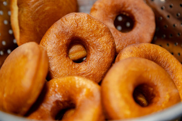 Fresh, golden brown and homely cooked Donuts. Focused and defocused on donuts.