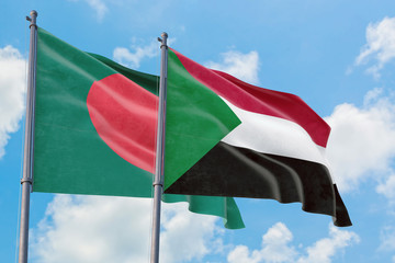 Sudan and Bangladesh flags waving in the wind against white cloudy blue sky together. Diplomacy concept, international relations.