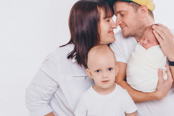 the concept of a healthy lifestyle, the protection of children, shopping - baby in the arms of the mother and wather. Woman and man holding a child