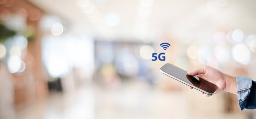 5G High speed internet network telecommunication, Hand using mobile phone with 5G technology signal icon over blur background with copy space, Internet of things banner, template