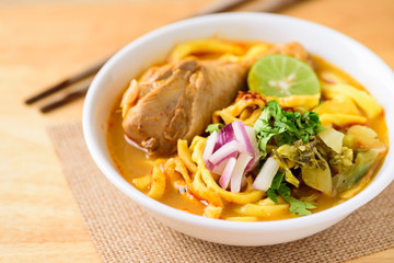 Northern Thai food (Khao Soi Kai), spicy egg noodles soup with chicken in a bowl