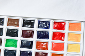 Multi-colored paints in squares. Watercolor paints. Close-up.