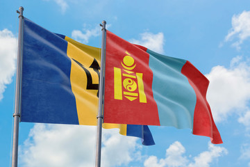 Mongolia and Barbados flags waving in the wind against white cloudy blue sky together. Diplomacy concept, international relations.