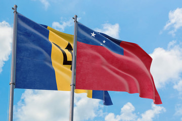 Samoa and Barbados flags waving in the wind against white cloudy blue sky together. Diplomacy concept, international relations.