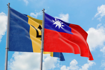 Taiwan and Barbados flags waving in the wind against white cloudy blue sky together. Diplomacy concept, international relations.