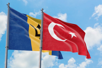 Turkey and Barbados flags waving in the wind against white cloudy blue sky together. Diplomacy concept, international relations.