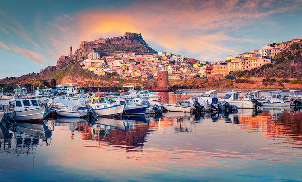 Calm evening cityscape of Castelsardo port. Marvelous sunset on Sardinia island, Province of Sassari, Italy, Europe. Fantastic spring seascape of Mediterranean sea. Traveling concept background.