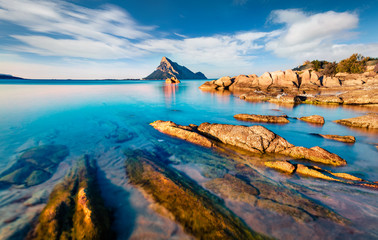 Impressive summer view of Sardinia island, Italy, Europe. Sunny morning scene of Porto Taverna beach with Tavolara mountain on background. Wonderful seascape of Mediterranean Sea.