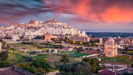 Fantastic morning cityscape of Ostuni town. Adorable spring sunrise in Apulia, Italy, Europe. Traveling concept background.