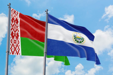 El Salvador and Belarus flags waving in the wind against white cloudy blue sky together. Diplomacy concept, international relations.