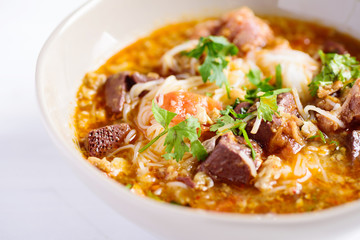 Northern Thai food (Kanom Jeen Nam Ngeaw), rice noodles with spicy soup in a bowl, close up