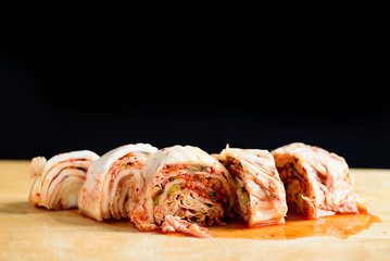 Kimchi cabbage on wooden board and black background, Korean food