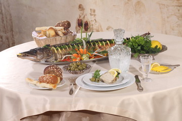 Table served with stuffed pike, vodka, moonshine in a restaurant