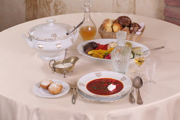 Still-life with borsch with vodka on a festive table