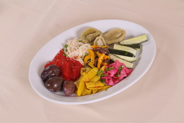 Plate with marinades: cucumbers, tomatoes, cabbage, peppers, plums