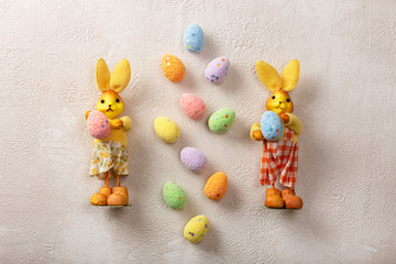 Easter. Easter bunnies and eggs on a light concrete background.