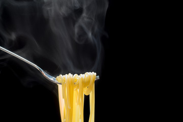 The steam and smoke from Spaghetti on a fork.delicious appetizing classic spaghetti pasta,.Space...