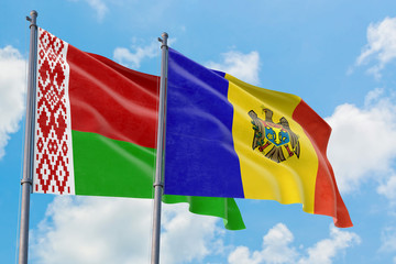 Moldova and Belarus flags waving in the wind against white cloudy blue sky together. Diplomacy concept, international relations.