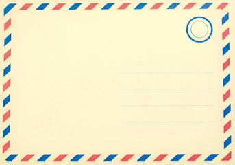 Empty faded retro postcard made of aged paper with copy space for the address and text and blue ink...