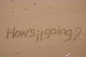 inscription on the sand, Handwriting  words "How's it going?" on sand of beach.