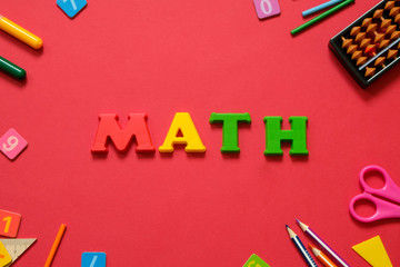 Math concept: colorful pens and pencils, number, calculating sticks in red background