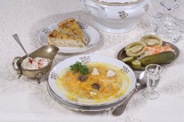 chicken soup with vermicelli, a glass of vodka and pickles