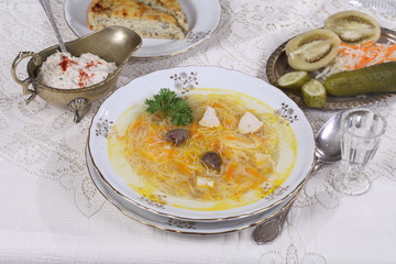 chicken soup with vermicelli, a glass of vodka and pickles
