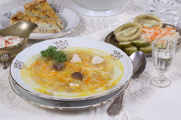 chicken soup with vermicelli, a glass of vodka and pickles